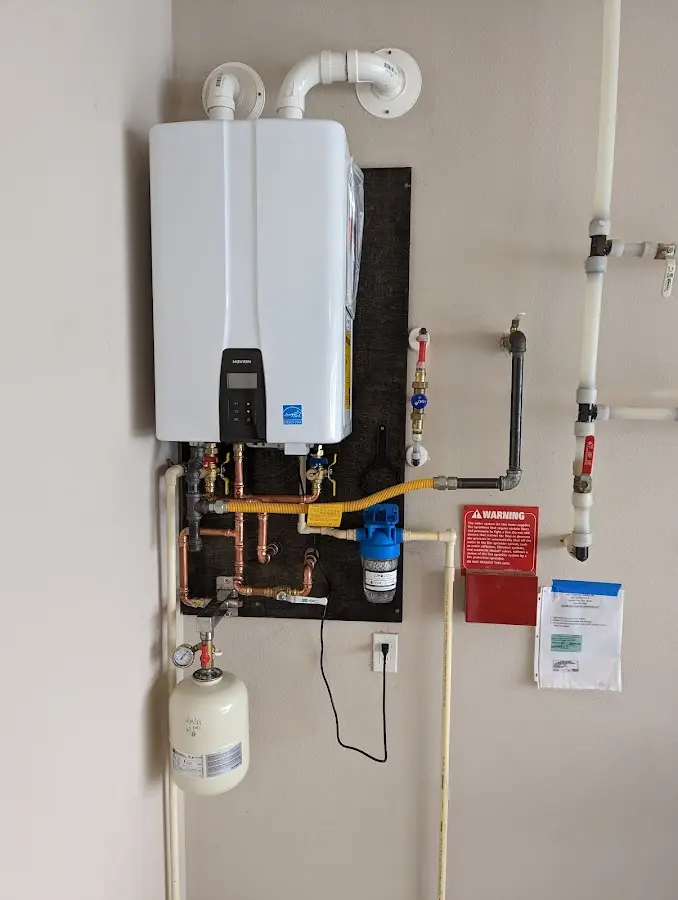 Professional plumber installing copper piping in a Glassboro home